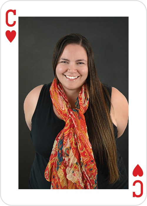 a woman smiling with a scarf around her neck