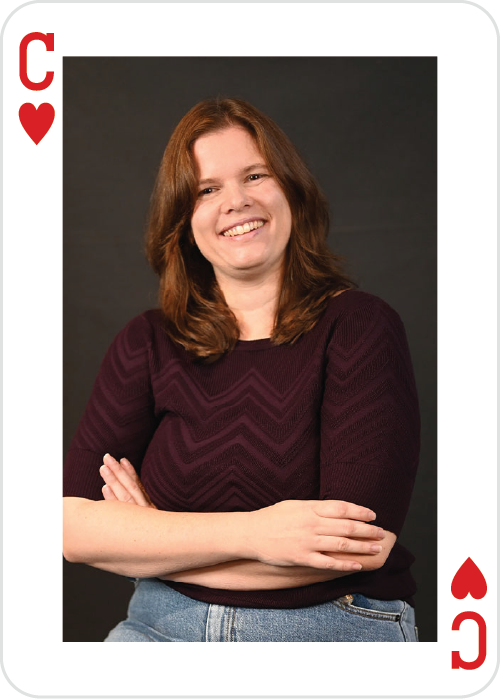 a woman smiling with arms crossed