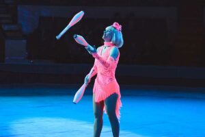 a woman juggling with juggling clubs