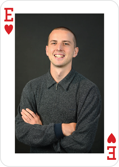 a man smiling with arms crossed