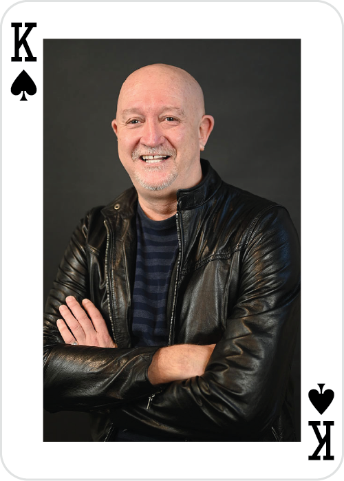 a man smiling with his arms crossed